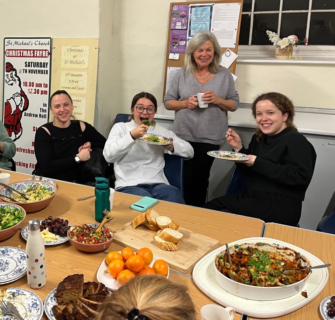 Treasurer Lucy Lucey serves some delicious food to keep the soloists and orchestra in full energy after the dress rehearsal